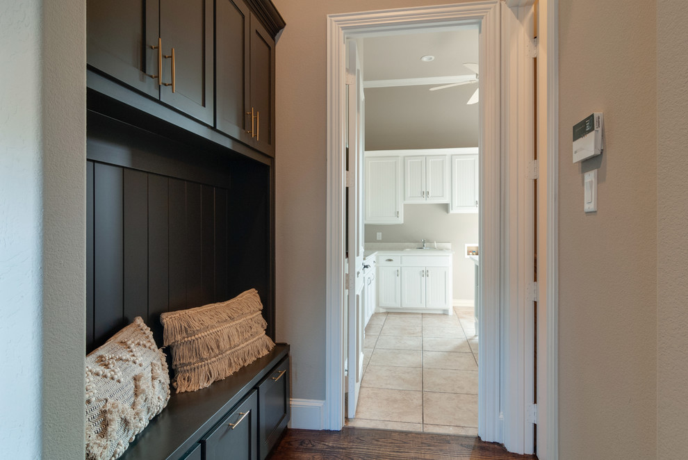 Design ideas for a small transitional single-wall dedicated laundry room in Dallas with a single-bowl sink, shaker cabinets, black cabinets, quartz benchtops, beige walls, porcelain floors, a side-by-side washer and dryer, beige floor and white benchtop.