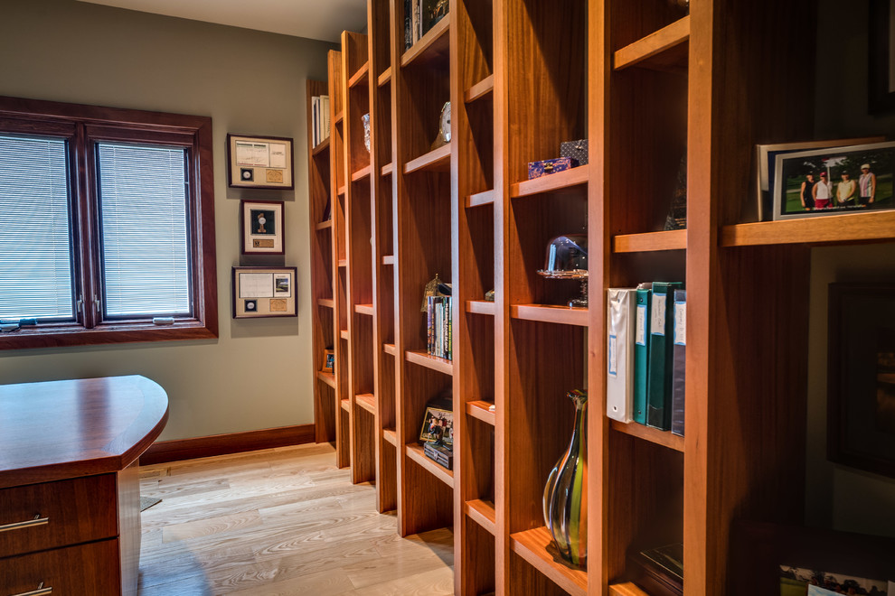 Photo of a traditional home office in Kansas City with light hardwood floors, no fireplace and a built-in desk.