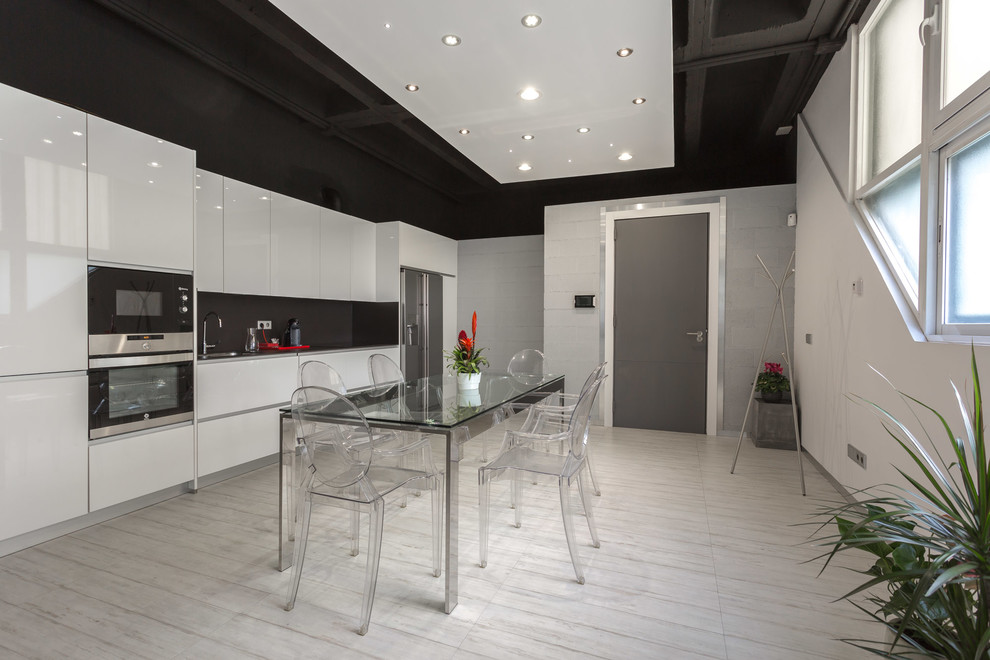 Design ideas for a contemporary single-wall eat-in kitchen in Madrid with a drop-in sink, flat-panel cabinets, white cabinets, grey splashback, stainless steel appliances, painted wood floors, no island and white floor.