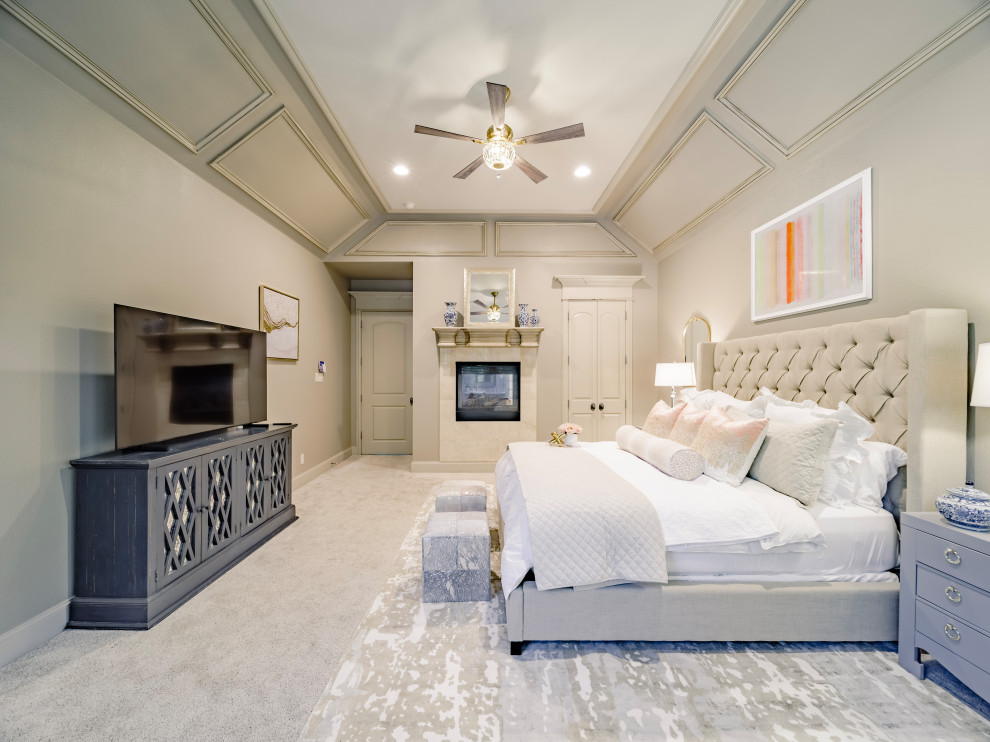 This is an example of a large transitional master bedroom in Dallas with beige walls, carpet, a two-sided fireplace, a tile fireplace surround, beige floor and coffered.