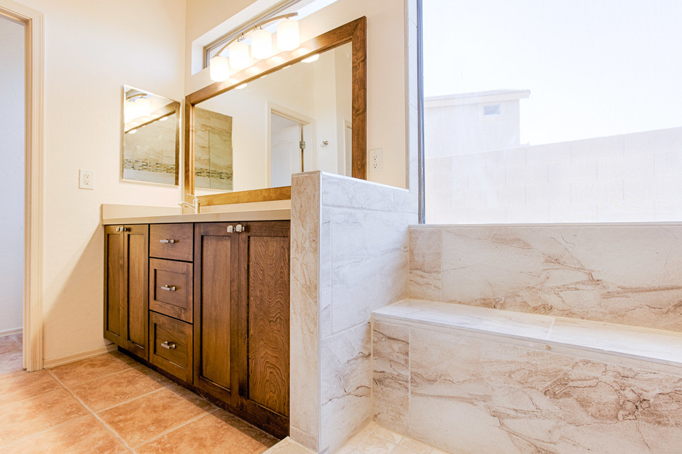 Example of a large transitional master gray tile and porcelain tile doorless shower design in Phoenix with recessed-panel cabinets, medium tone wood cabinets, beige walls, an undermount sink and quartzite countertops