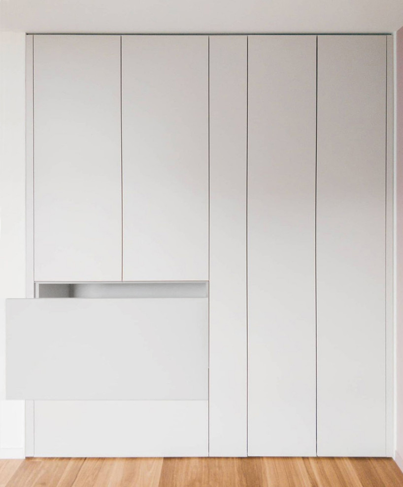 Mid-sized scandinavian storage and wardrobe in Other with beaded inset cabinets and beige cabinets.