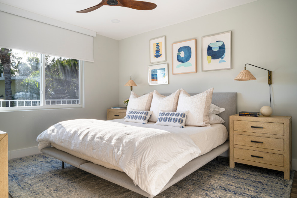 Photo of a mid-sized beach style master bedroom in Miami with grey walls, porcelain floors and brown floor.