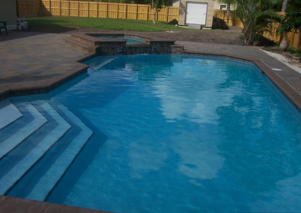Example of a transitional backyard tile and rectangular natural hot tub design in Miami
