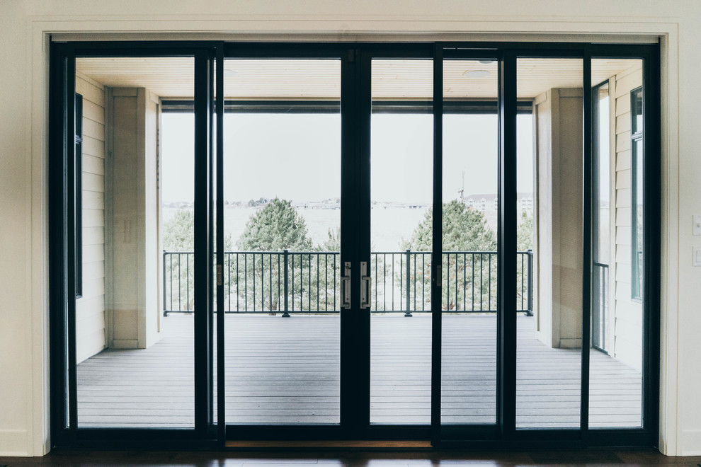 Transitional dark wood floor enclosed dining room photo in Omaha with a two-sided fireplace