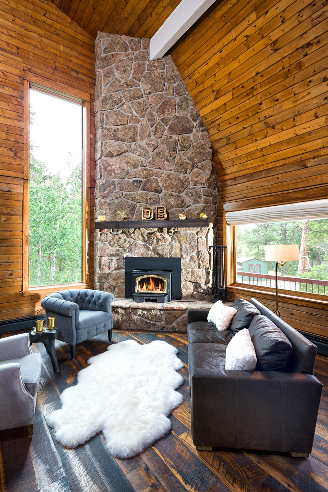 Mid-sized mountain style open concept dark wood floor and brown floor living room photo in Denver with brown walls, a corner fireplace and a stone fireplace