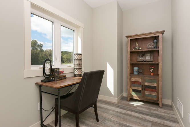 Photo of a mid-sized industrial home office in Minneapolis with grey walls, no fireplace and a freestanding desk.