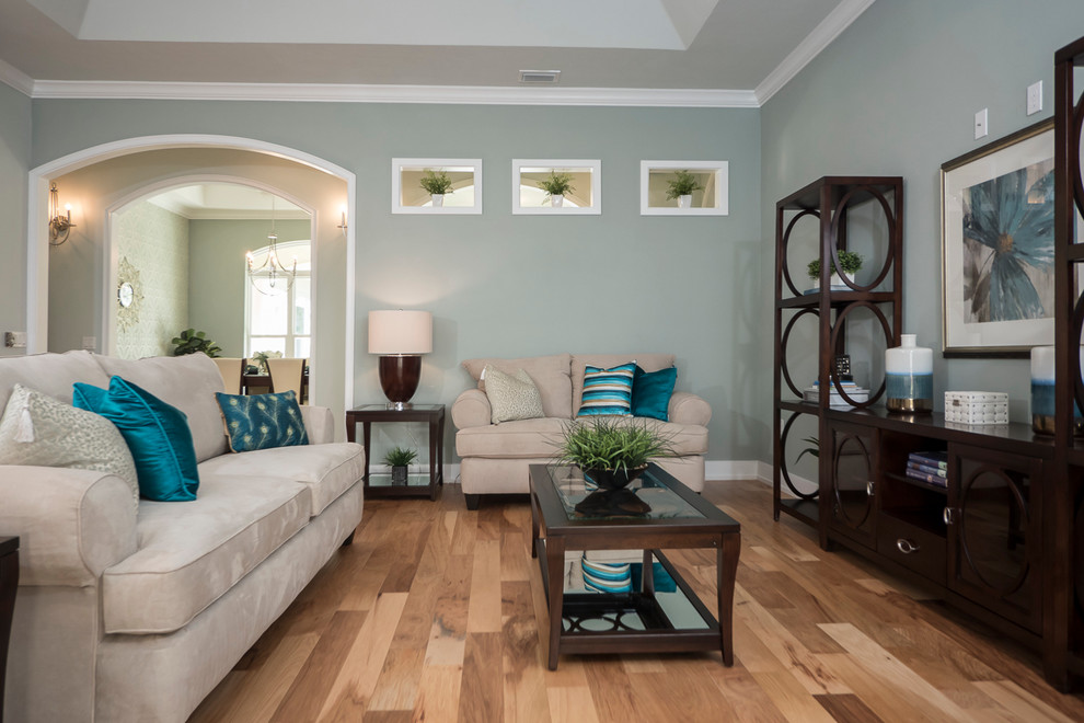 Design ideas for a contemporary family room in Jacksonville with light hardwood floors, no fireplace and blue walls.