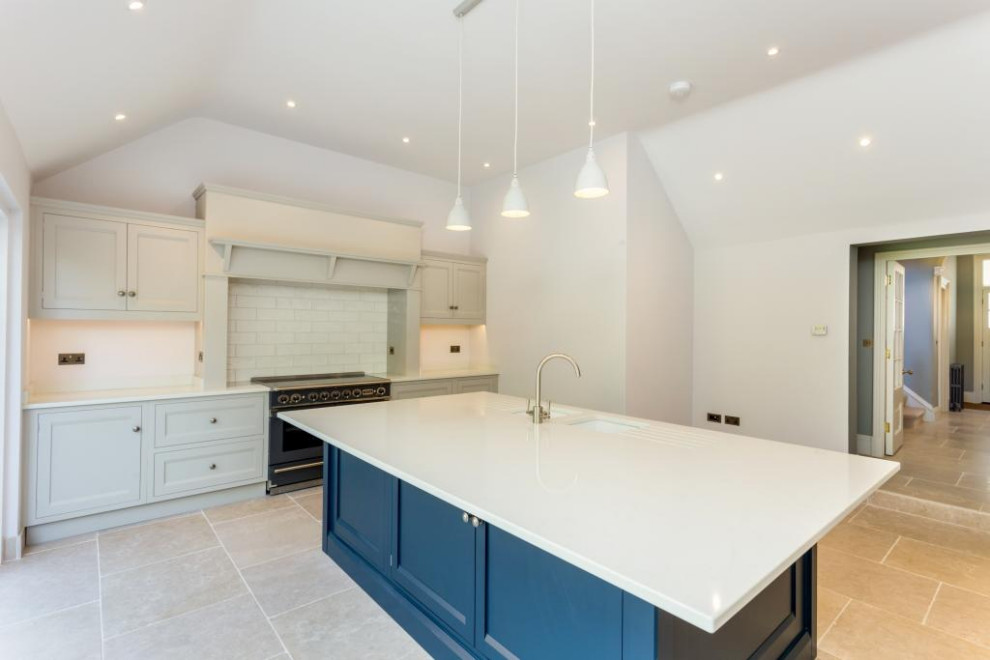 Design ideas for a contemporary eat-in kitchen in Oxfordshire with with island, solid surface benchtops, white splashback and white benchtop.