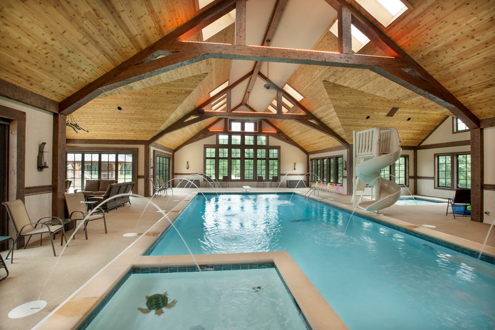 Design ideas for a traditional indoor pool in Columbus with a water feature.