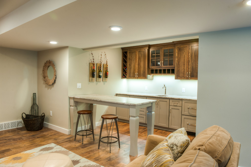 This is an example of a mid-sized contemporary single-wall wet bar in Other with recessed-panel cabinets, quartzite benchtops, an undermount sink, beige cabinets, blue splashback and medium hardwood floors.