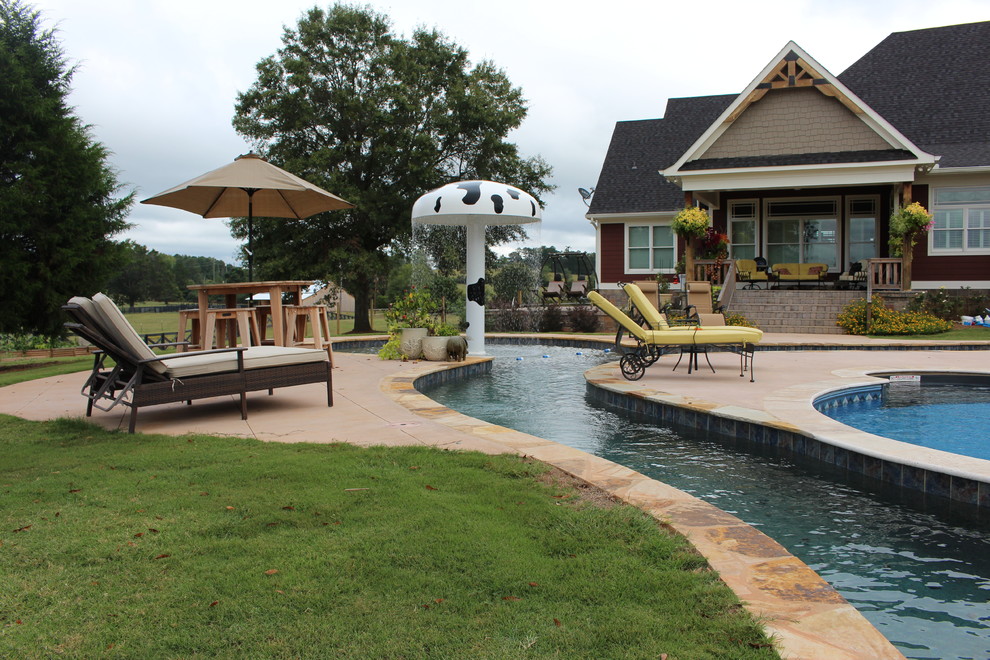 Design ideas for an expansive country backyard custom-shaped pool in Atlanta with a water feature.