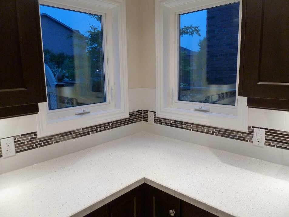 Inspiration for a transitional porcelain tile and beige floor eat-in kitchen remodel in Toronto with a double-bowl sink, shaker cabinets, dark wood cabinets, quartz countertops, white backsplash, subway tile backsplash, stainless steel appliances and white countertops