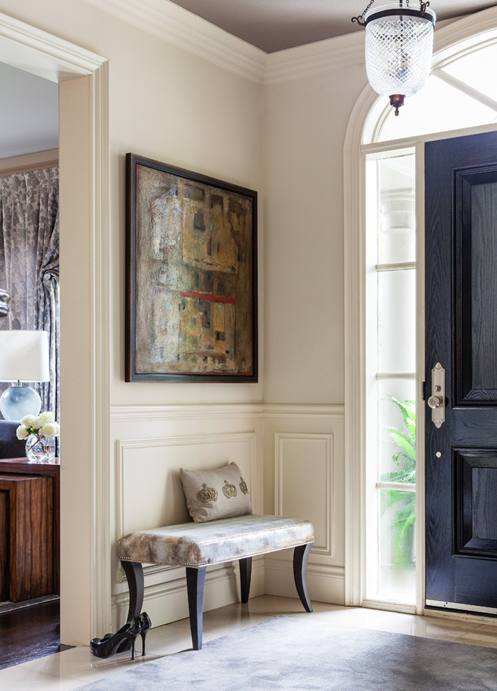 This is an example of a traditional foyer in Toronto with beige walls, a single front door and a dark wood front door.