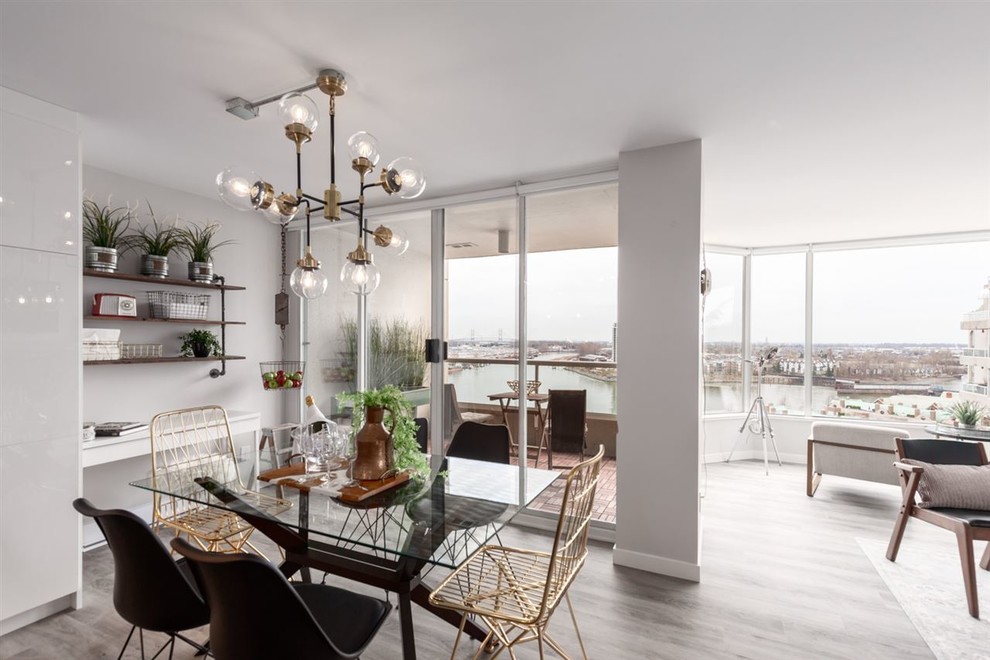 Example of a mid-sized urban medium tone wood floor and beige floor great room design in Vancouver with white walls and no fireplace