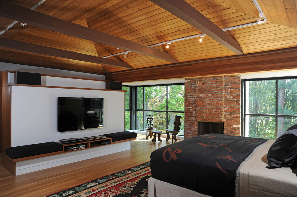Contemporary bedroom in Boston with white walls and medium hardwood floors.