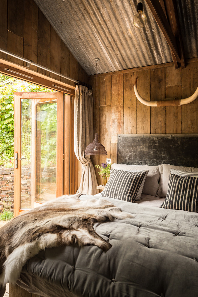 Inspiration for a country master bedroom in Cornwall with medium hardwood floors.