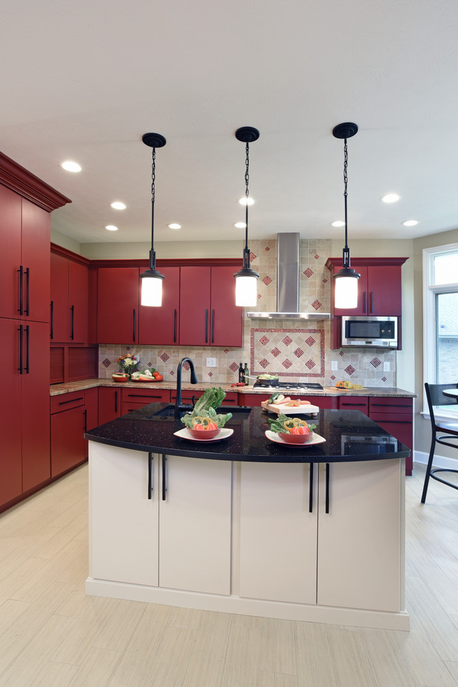 Inspiration for a large transitional porcelain tile and beige floor enclosed kitchen remodel with an undermount sink, flat-panel cabinets, red cabinets, granite countertops, beige backsplash, travertine backsplash, stainless steel appliances and an island