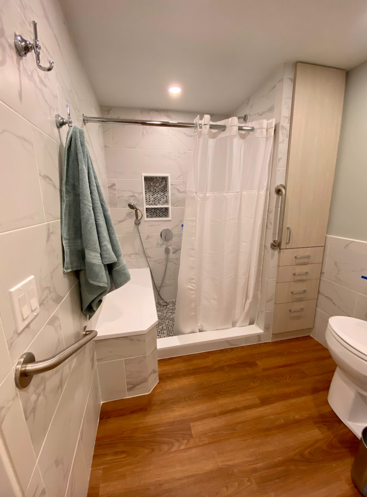 Inspiration for a medium sized classic ensuite bathroom in Philadelphia with flat-panel cabinets, light wood cabinets, an alcove shower, a two-piece toilet, white tiles, ceramic tiles, green walls, vinyl flooring, a submerged sink, engineered stone worktops, brown floors, a shower curtain, white worktops, a shower bench, a single sink, a built in vanity unit and wainscoting.