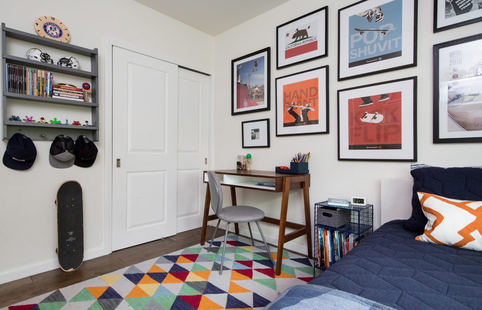 Photo of an eclectic kids' room for boys in Los Angeles with white walls, dark hardwood floors and brown floor.