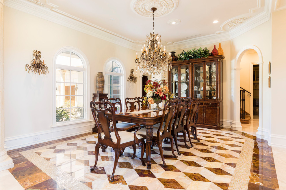 Large mediterranean separate dining room in Orlando with beige walls, marble floors, no fireplace and multi-coloured floor.