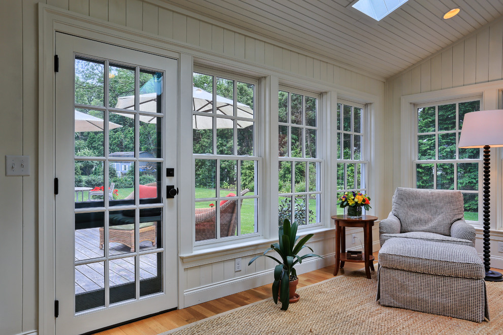 Photo of a sunroom in Other with medium hardwood floors, no fireplace and a skylight.