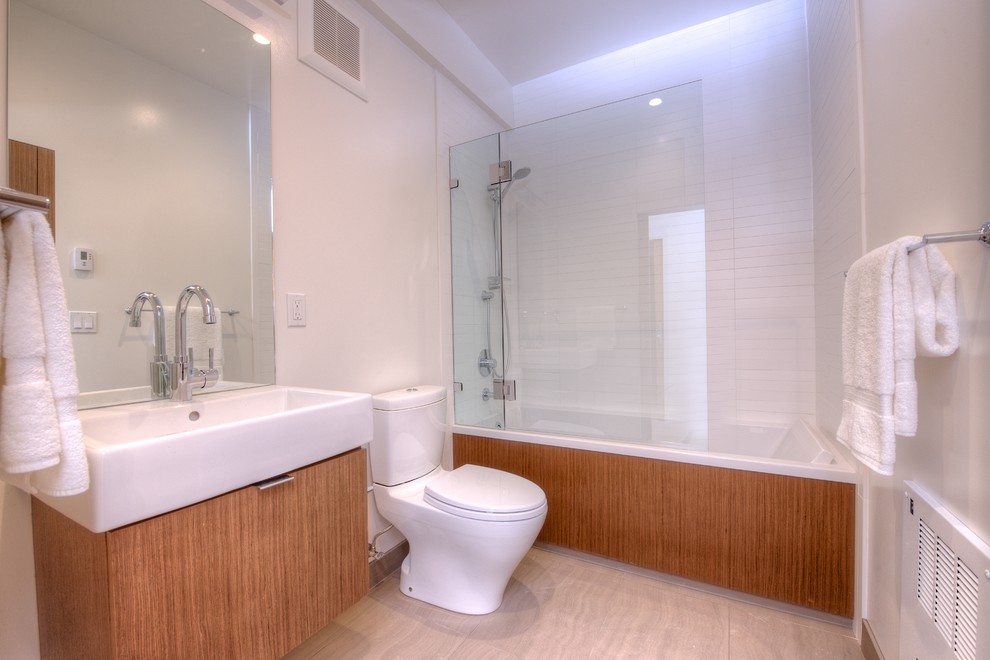 Mid-sized contemporary bathroom in San Francisco with light wood cabinets and a shower/bathtub combo.