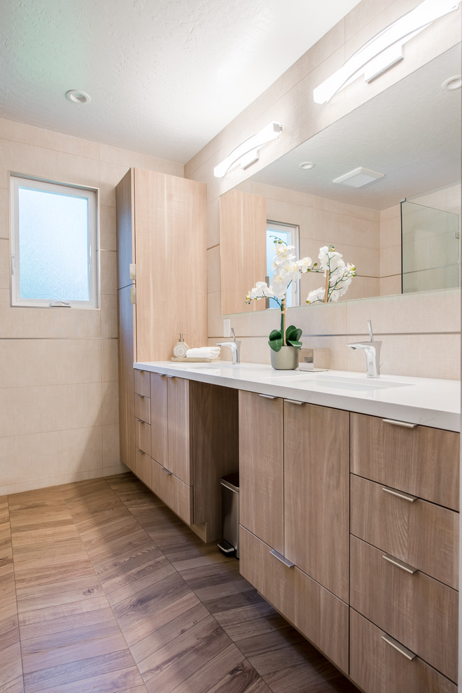 This is an example of a mid-sized modern master bathroom in San Francisco with medium hardwood floors, brown floor, flat-panel cabinets, light wood cabinets, a curbless shower, a bidet, beige tile, ceramic tile, beige walls, an undermount sink, granite benchtops and white benchtops.