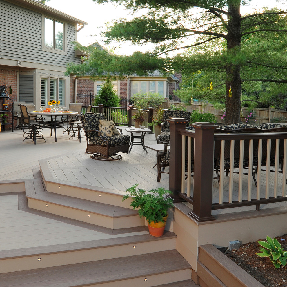 Large traditional backyard deck in New York with a pergola.