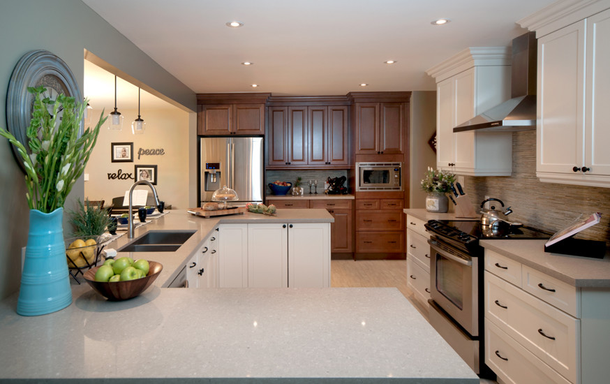 Design ideas for a mid-sized transitional u-shaped separate kitchen in Toronto with an undermount sink, shaker cabinets, white cabinets, quartz benchtops, beige splashback, stainless steel appliances, ceramic floors, matchstick tile splashback and a peninsula.