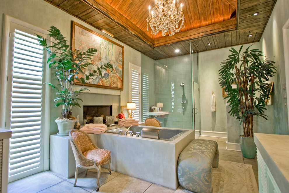 This is an example of a tropical bathroom in Little Rock with a drop-in tub.