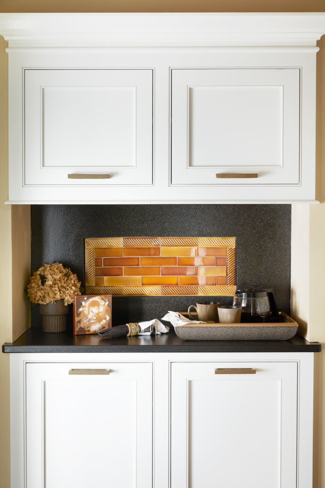 Design ideas for a traditional single-wall dry bar in Other with no sink, recessed-panel cabinets, white cabinets, granite worktops, orange splashback, granite splashback and black worktops.