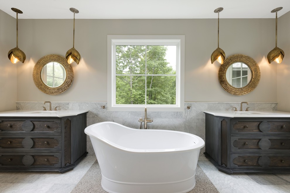 Photo of a large traditional master bathroom in Minneapolis with a freestanding tub, grey walls, marble floors, an undermount sink, quartzite benchtops, white floor, dark wood cabinets and recessed-panel cabinets.