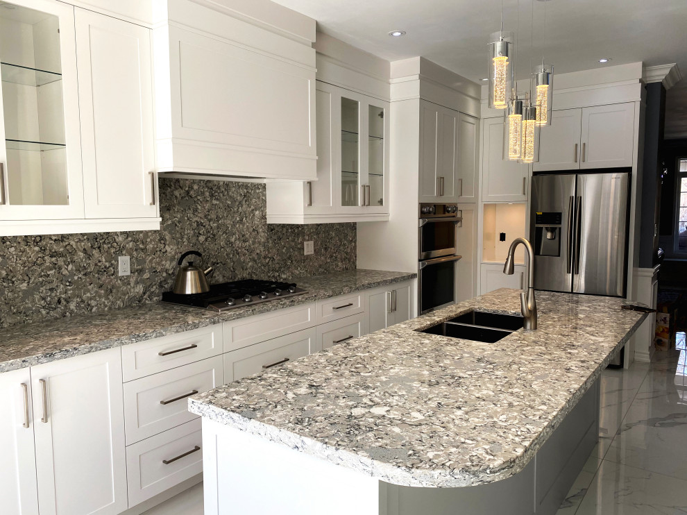 Inspiration for a large transitional l-shaped eat-in kitchen remodel in Toronto with flat-panel cabinets, white cabinets and an island