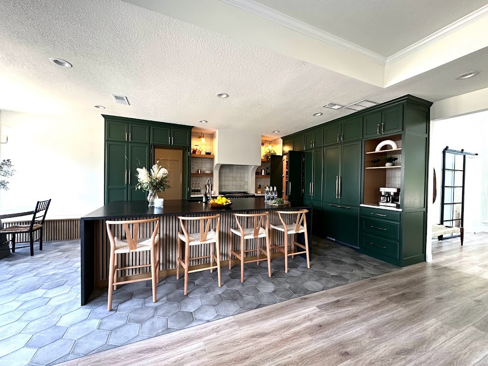 Inspiration for a large transitional l-shaped kitchen pantry in Dallas with a single-bowl sink, shaker cabinets, green cabinets, quartzite benchtops, white splashback, ceramic splashback, panelled appliances, porcelain floors, with island, grey floor and black benchtop.