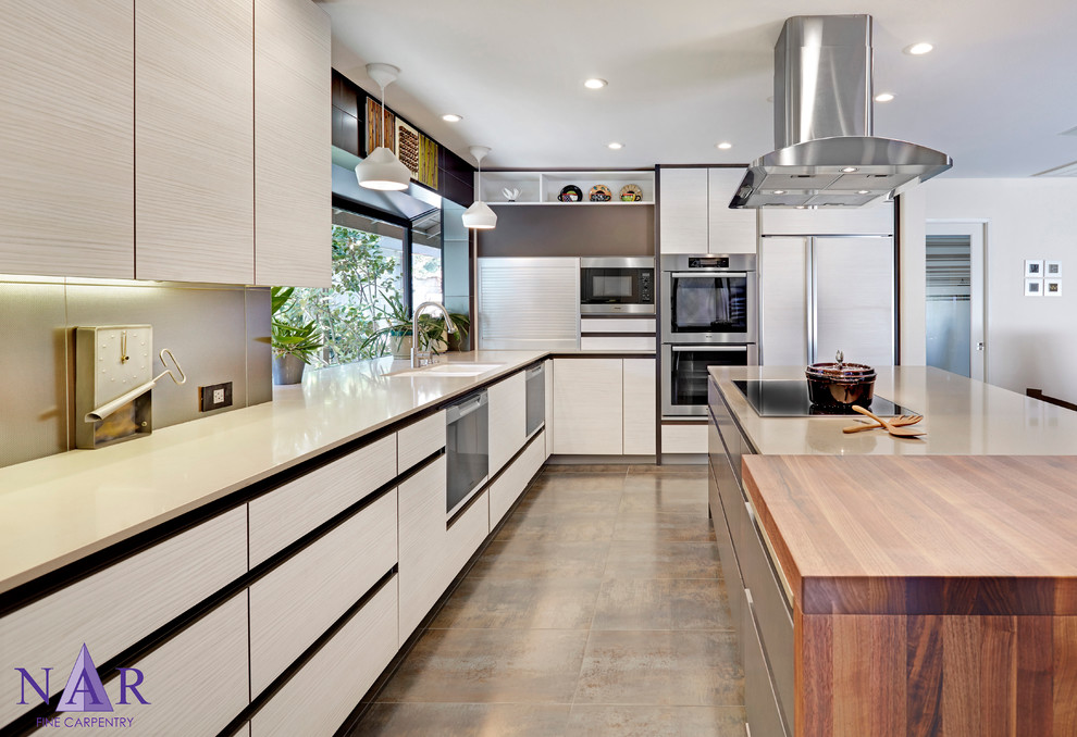 Example of a mid-sized trendy l-shaped porcelain tile open concept kitchen design in Other with a double-bowl sink, flat-panel cabinets, dark wood cabinets, quartz countertops, metallic backsplash, porcelain backsplash and paneled appliances