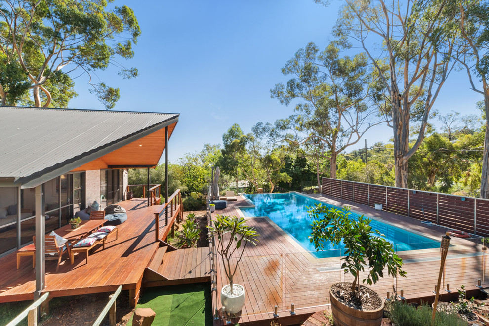 Contemporary backyard rectangular lap pool in Perth with decking.