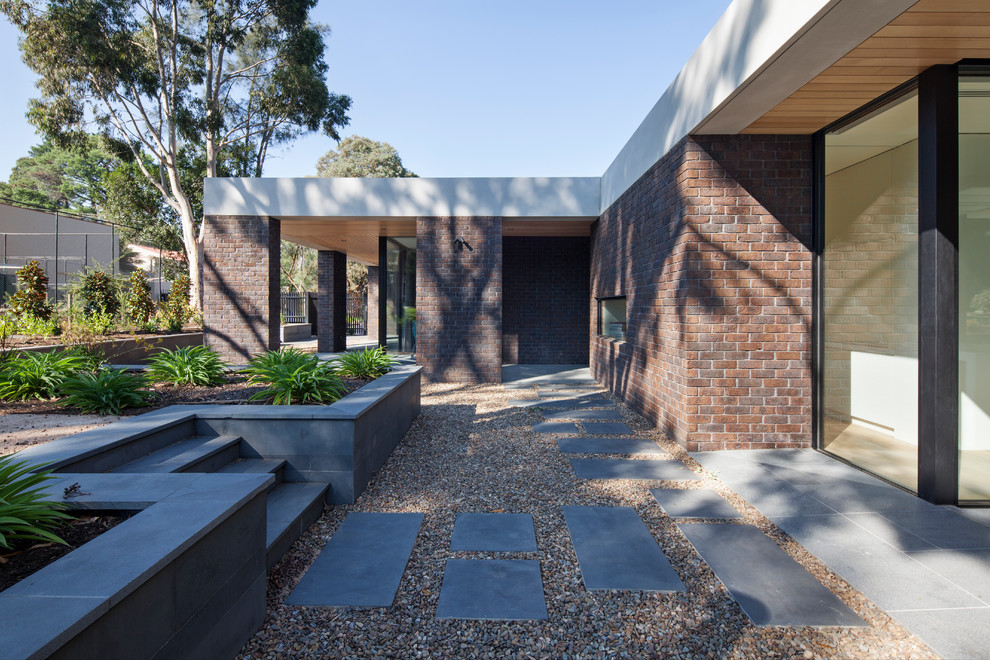 Design ideas for a large modern one-storey brick exterior in Melbourne.