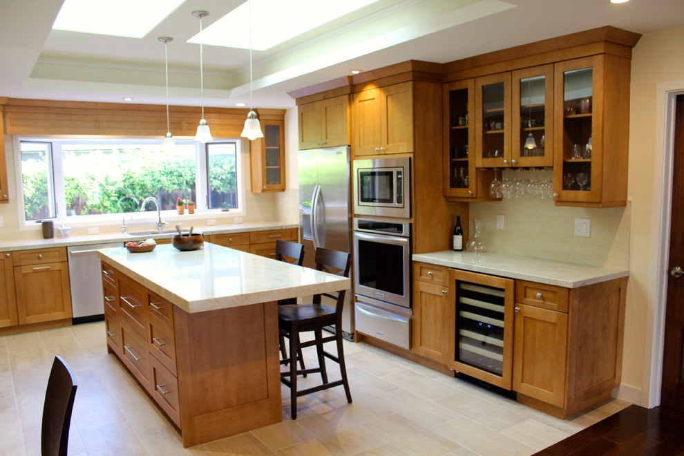Photo of a mid-sized modern u-shaped separate kitchen in San Francisco with an undermount sink, recessed-panel cabinets, medium wood cabinets, quartz benchtops, beige splashback, travertine splashback, stainless steel appliances, ceramic floors and with island.