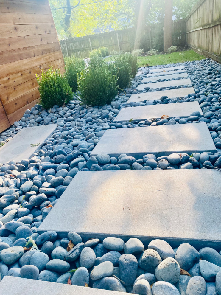 Immagine di un giardino minimalista con un focolare e pavimentazioni in cemento