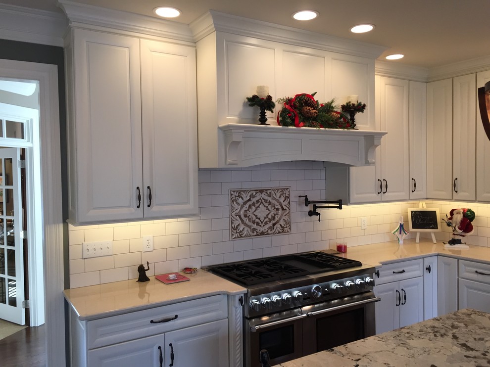 Eat-in kitchen - large transitional u-shaped dark wood floor eat-in kitchen idea in Indianapolis with an undermount sink, raised-panel cabinets, white cabinets, quartz countertops, white backsplash, subway tile backsplash, stainless steel appliances and an island
