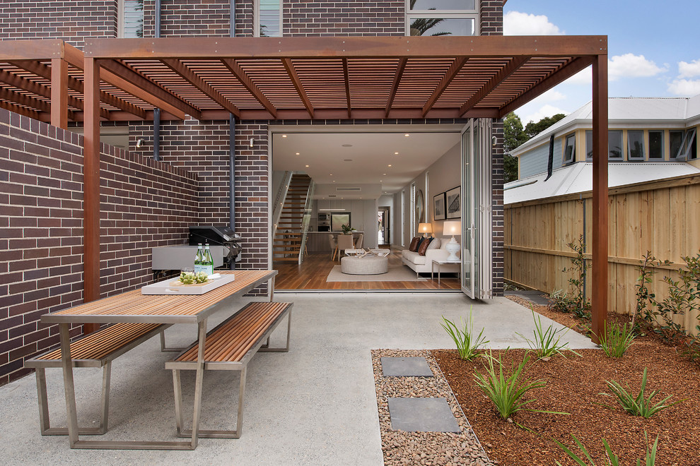 Design ideas for a mid-sized contemporary backyard patio in Melbourne with an outdoor kitchen and a pergola.