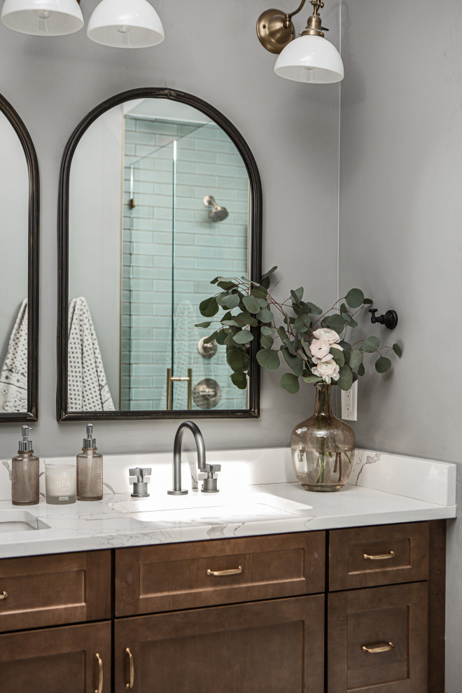 Example of a mid-sized transitional master green tile and ceramic tile porcelain tile, white floor, double-sink and wallpaper alcove shower design in Denver with shaker cabinets, dark wood cabinets, a one-piece toilet, gray walls, an undermount sink, quartz countertops, a hinged shower door, white countertops, a niche and a freestanding vanity