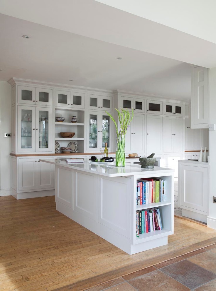 Transitional u-shaped eat-in kitchen in Dublin with an undermount sink, beaded inset cabinets, white cabinets, grey splashback, stone slab splashback and stainless steel appliances.