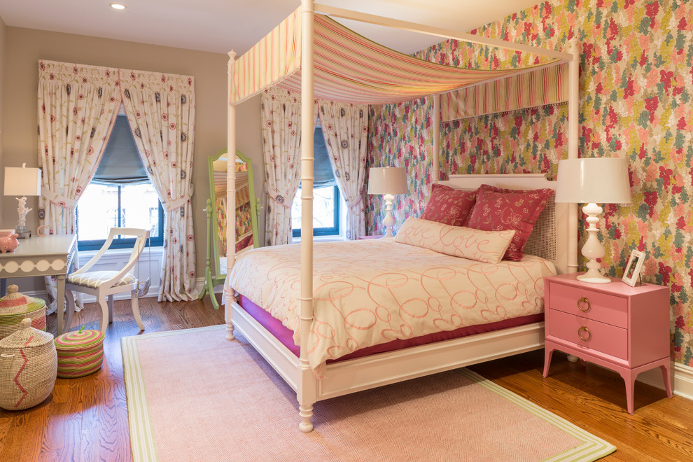 Photo of a mid-sized transitional kids' bedroom for kids 4-10 years old and girls in New York with multi-coloured walls and medium hardwood floors.