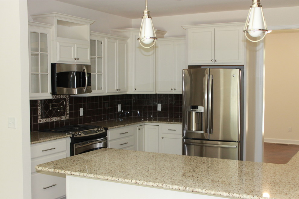Mid-sized transitional u-shaped dark wood floor eat-in kitchen photo with shaker cabinets, white cabinets, granite countertops, black backsplash, ceramic backsplash, stainless steel appliances, an island and a double-bowl sink