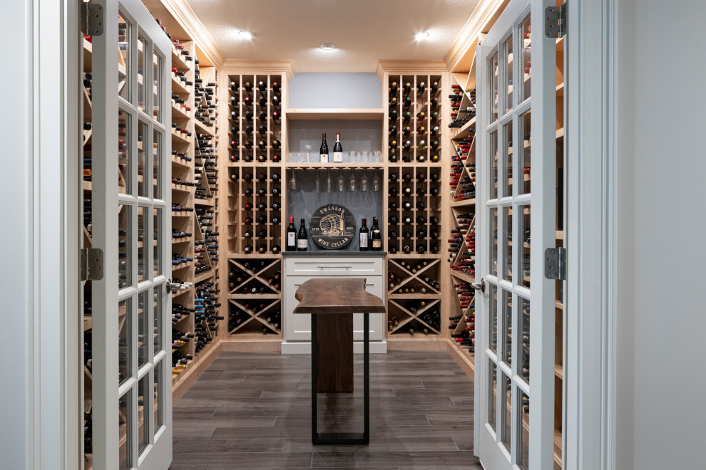 Mid-sized transitional wine cellar in Kansas City with ceramic floors, storage racks and brown floor.