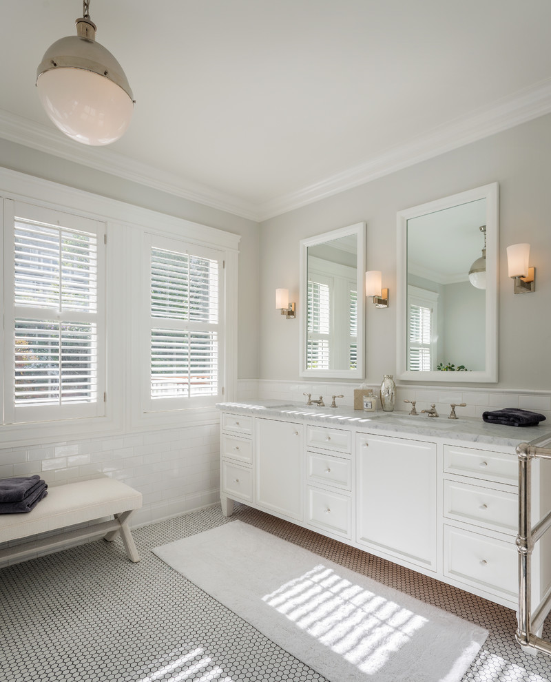 Photo of a transitional bathroom in San Francisco with an undermount sink, white cabinets, recessed-panel cabinets, white floor and grey benchtops.