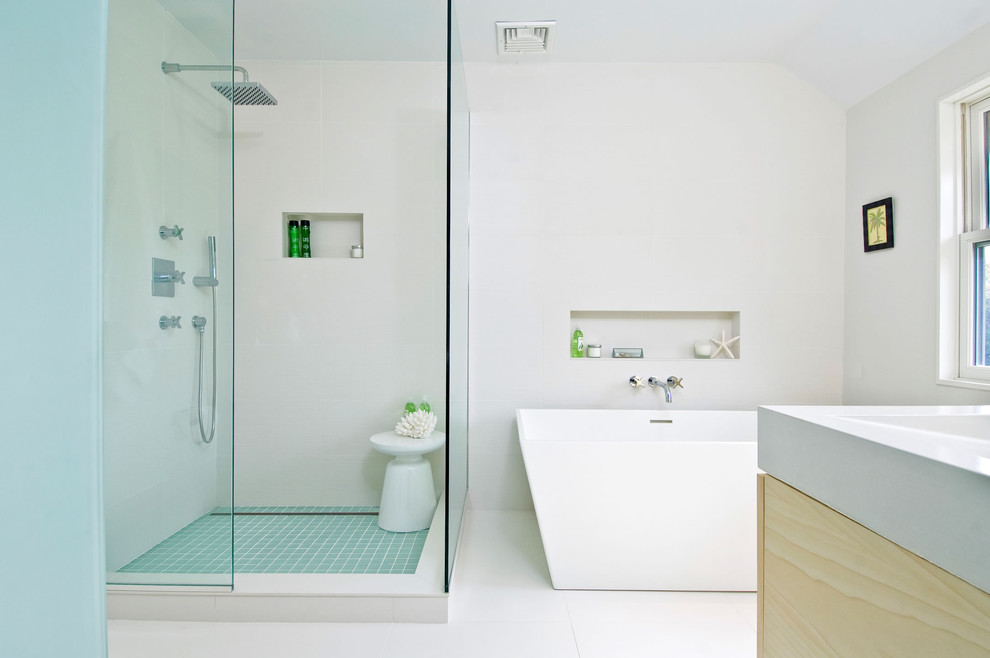 Inspiration for a contemporary bathroom in New York with a freestanding tub and white benchtops.