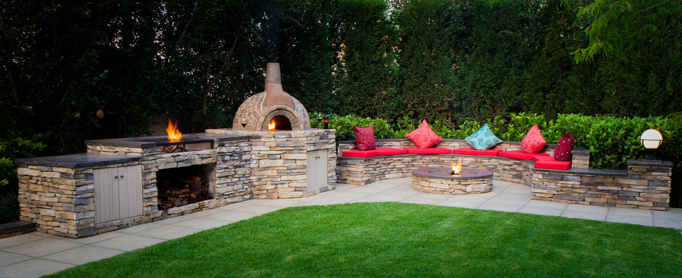This is an example of a rustic full sun backyard concrete paver landscaping.